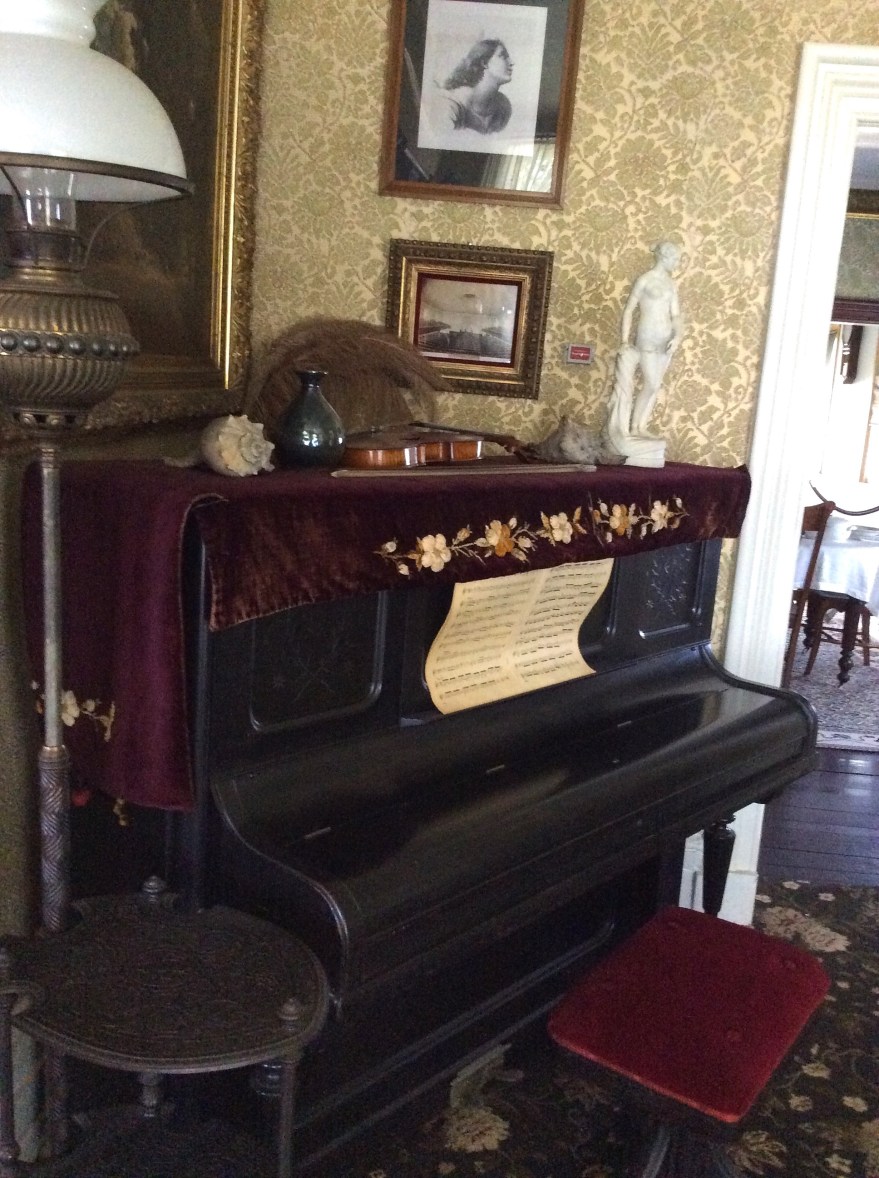Sitting room piano with Joseph Douglass' violin on top